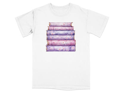 Stack of decorative floral books on a white t-shirt.