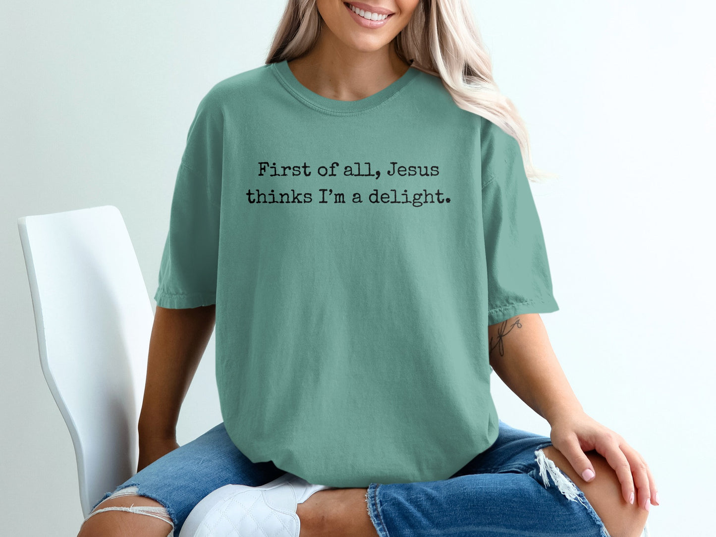 Teal t-shirt with "First of all, Jesus thinks I'm a delight." text.