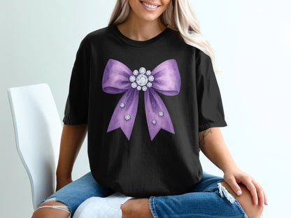 Black t-shirt with a large purple sequin bow and rhinestones.