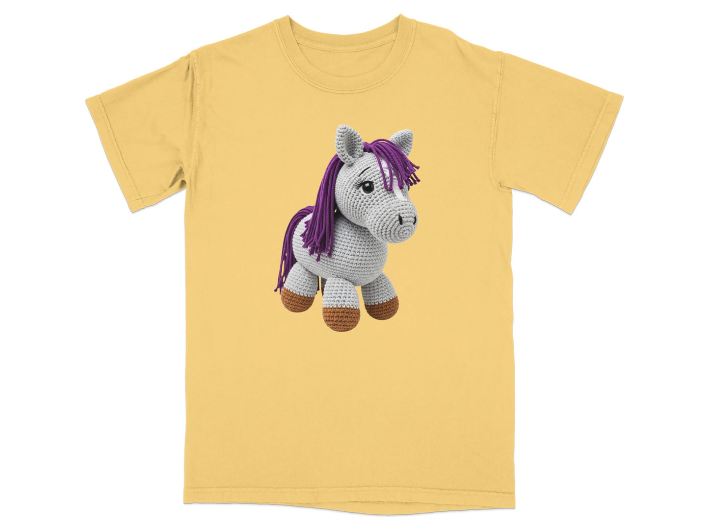 Yellow t-shirt with a crocheted purple and white horse toy.