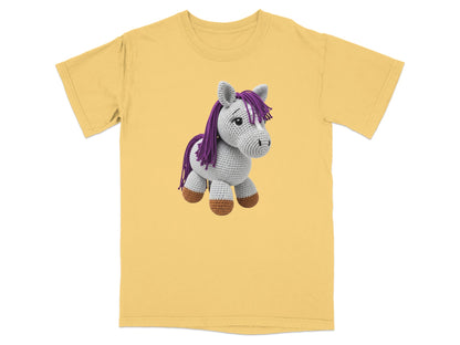 Yellow t-shirt with a crocheted purple and white horse toy.