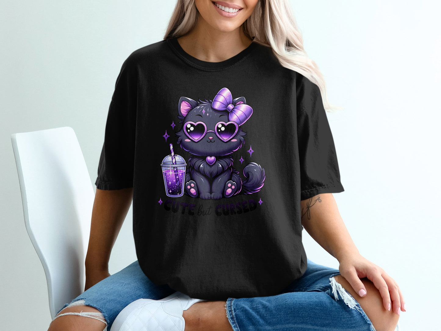 Black t-shirt with graphic of a cute black cat wearing heart sunglasses and a bow.