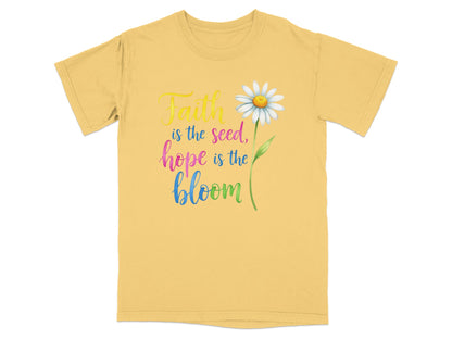 Yellow t-shirt with "Faith is the seed, hope is the bloom" text and daisy.