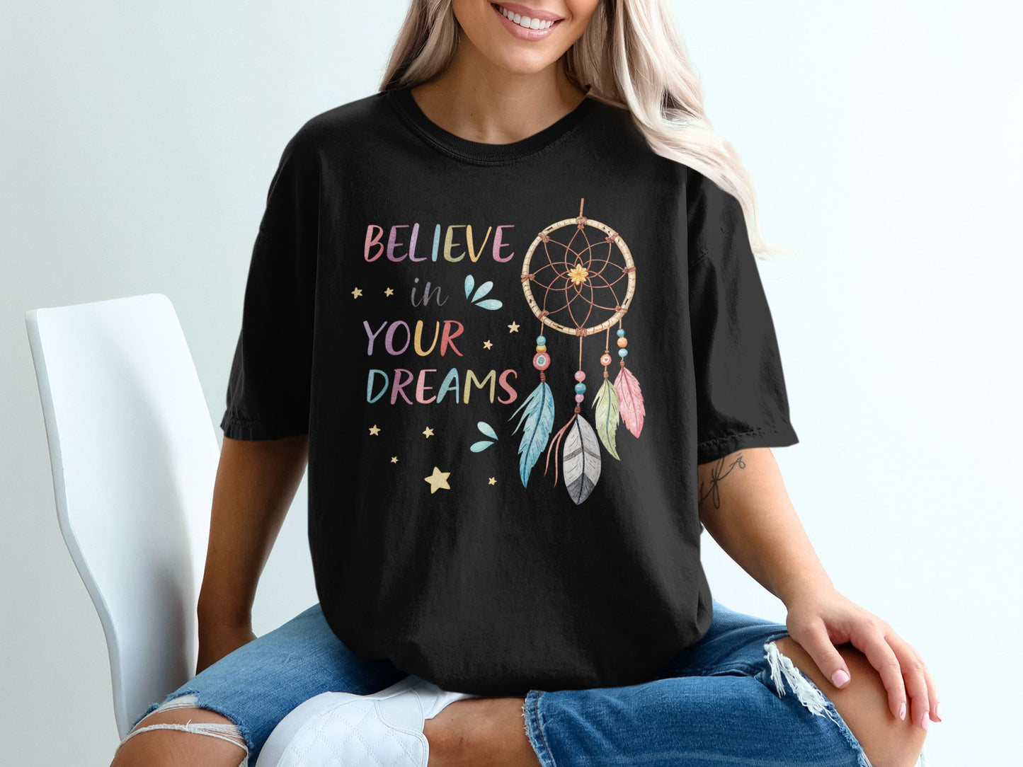 Black t-shirt with "BELIEVE in YOUR DREAMS" and dreamcatcher graphic.