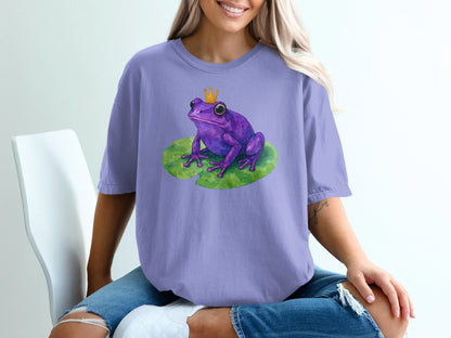 Purple frog with a crown sits on a lily pad.