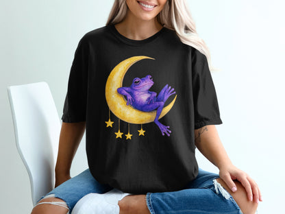 Black t-shirt with a purple frog sitting on a crescent moon with stars.