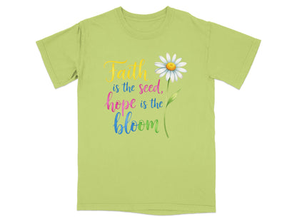 Light green t-shirt with "Faith is the seed, hope is the bloom" and a daisy.