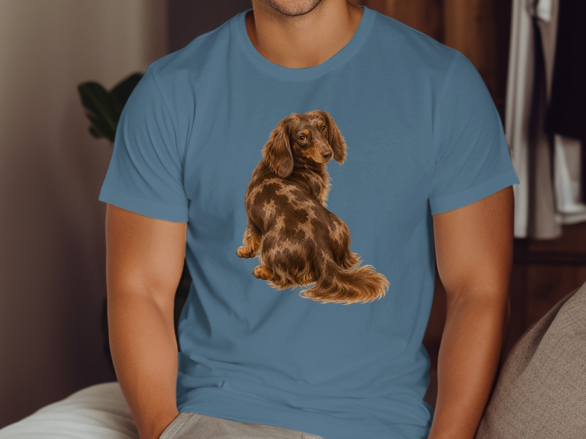 Blue t-shirt with a detailed illustration of a dapple dachshund sitting.