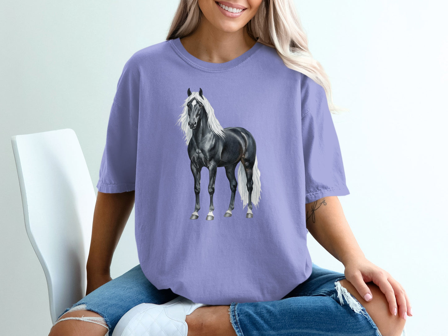 Black Friesian horse with white mane and tail on a purple t-shirt.