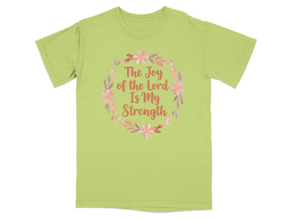 Light green t-shirt with floral wreath and text "The Joy of the Lord is My Strength."