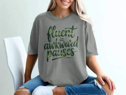 Gray t-shirt with "fluent in awkward pauses" text, worn by a woman.
