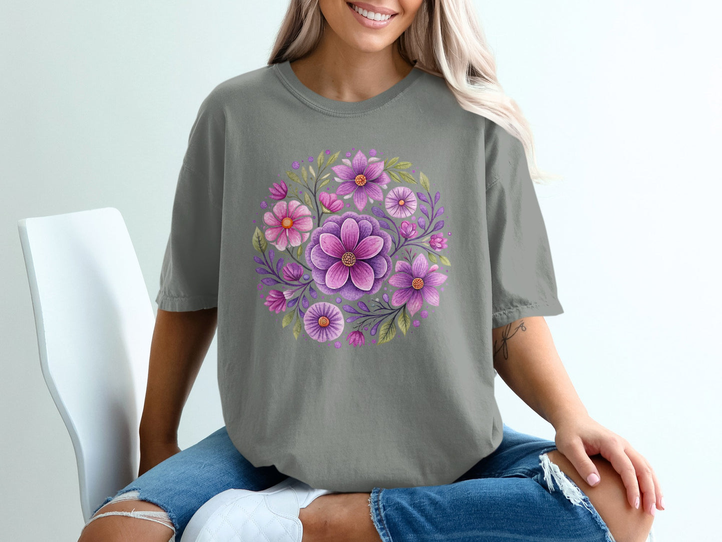 Gray t-shirt with circular floral design featuring pink and purple flowers and green leaves.