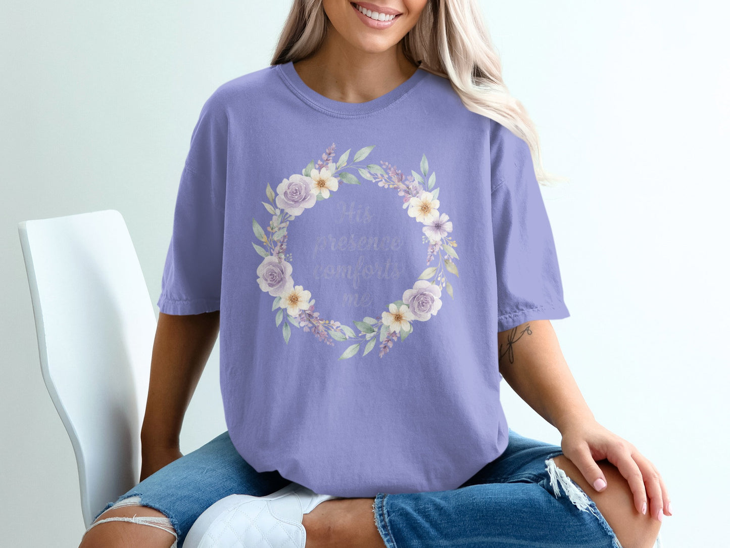 Lavender t-shirt with "His presence comforts me" floral wreath graphic.